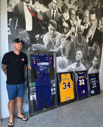 customer with four jerseys framed against wall