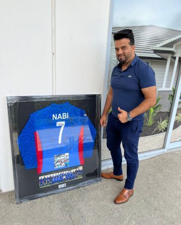 happy customer with framed jersey