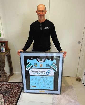 happy customer with framed sport jersey