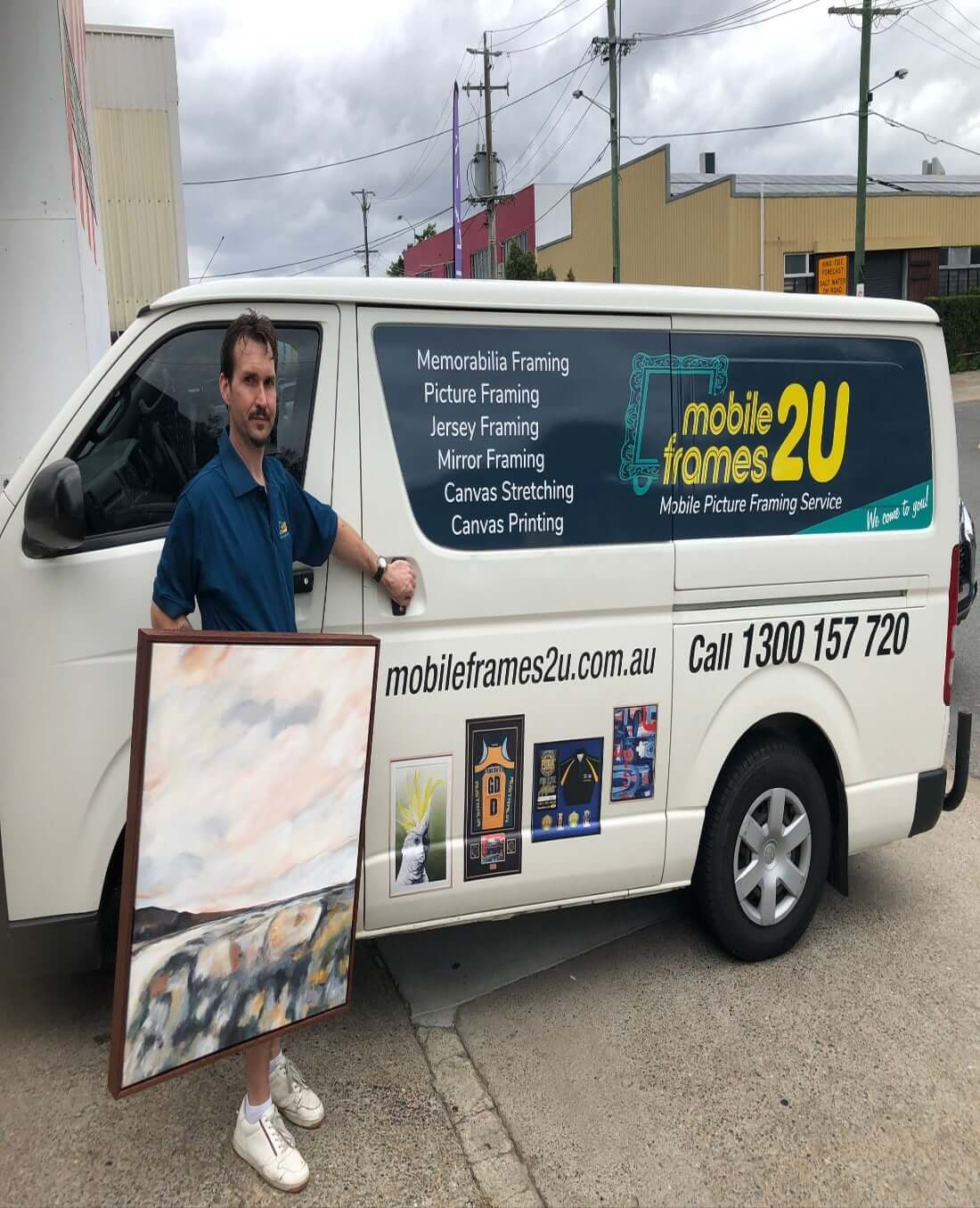 man-holding-frame-with-a-van