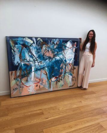 woman with large blue canvas with floating frame